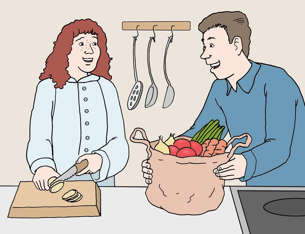 Frau und Mann am Herd mit Gemüse